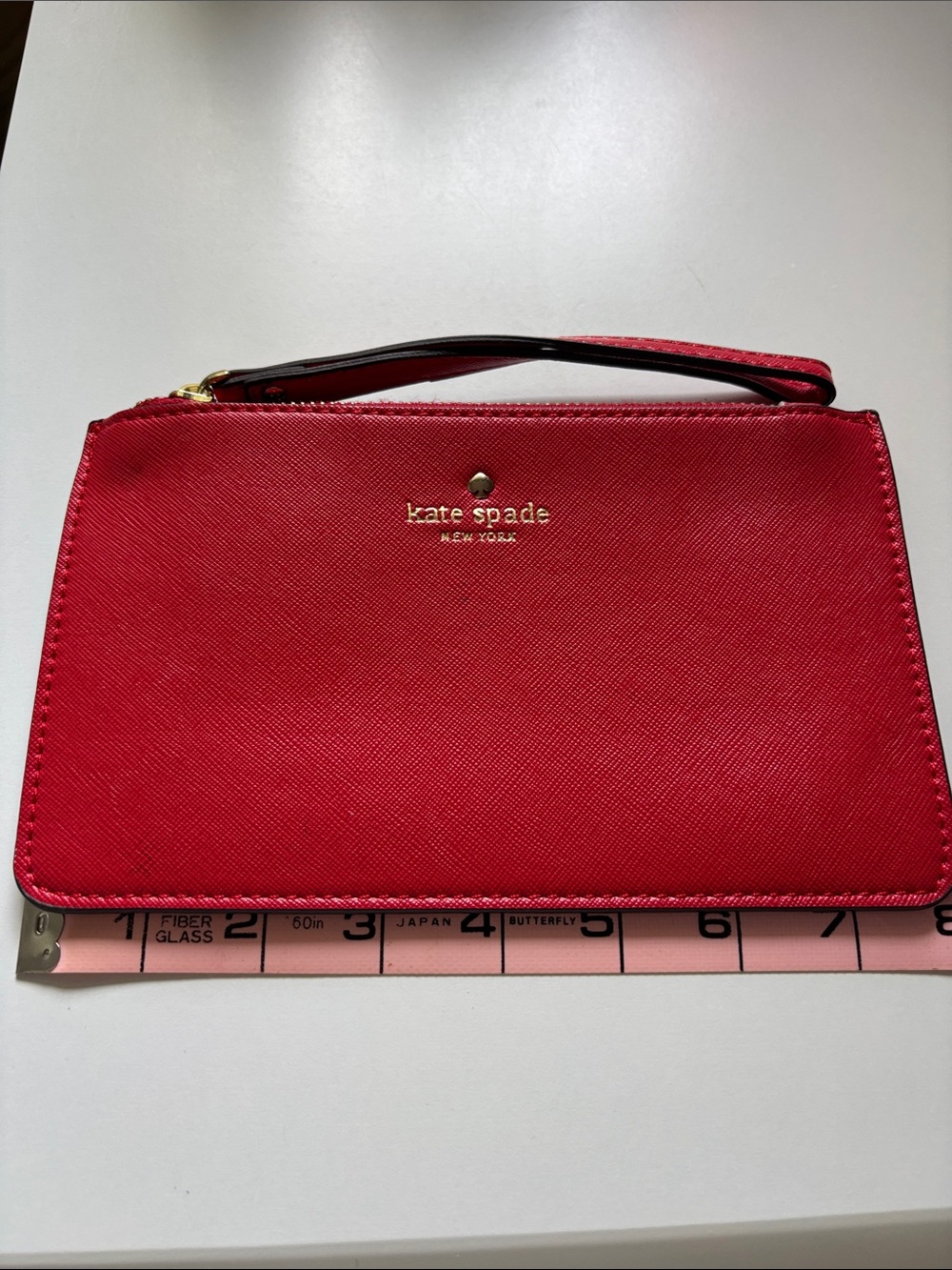 kate spade red wristlet clutch with gold logo